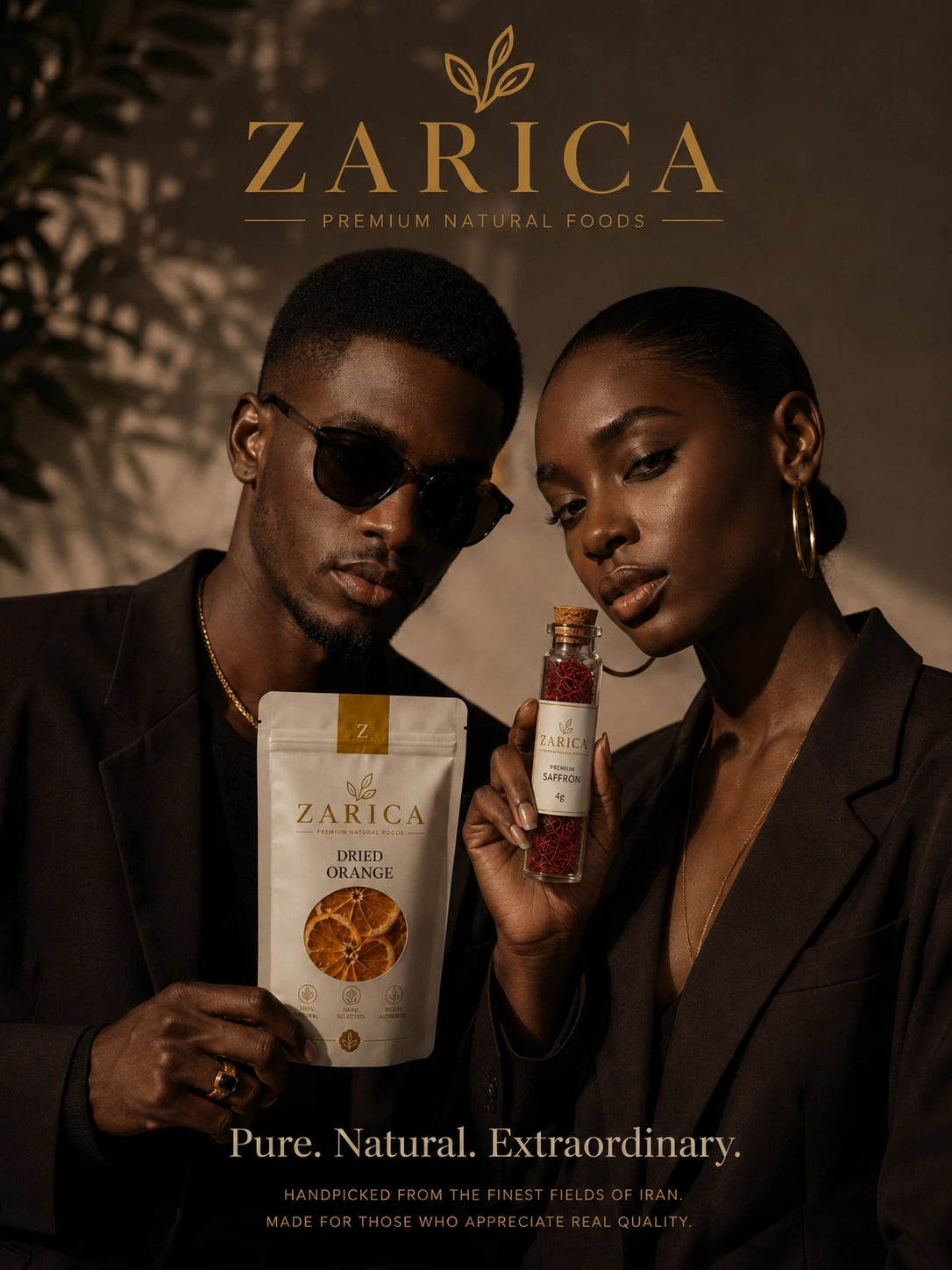 Two models in dark tailoring presenting ZARICA dried orange and a slender 4g saffron vial with the brand's three-leaf logo
